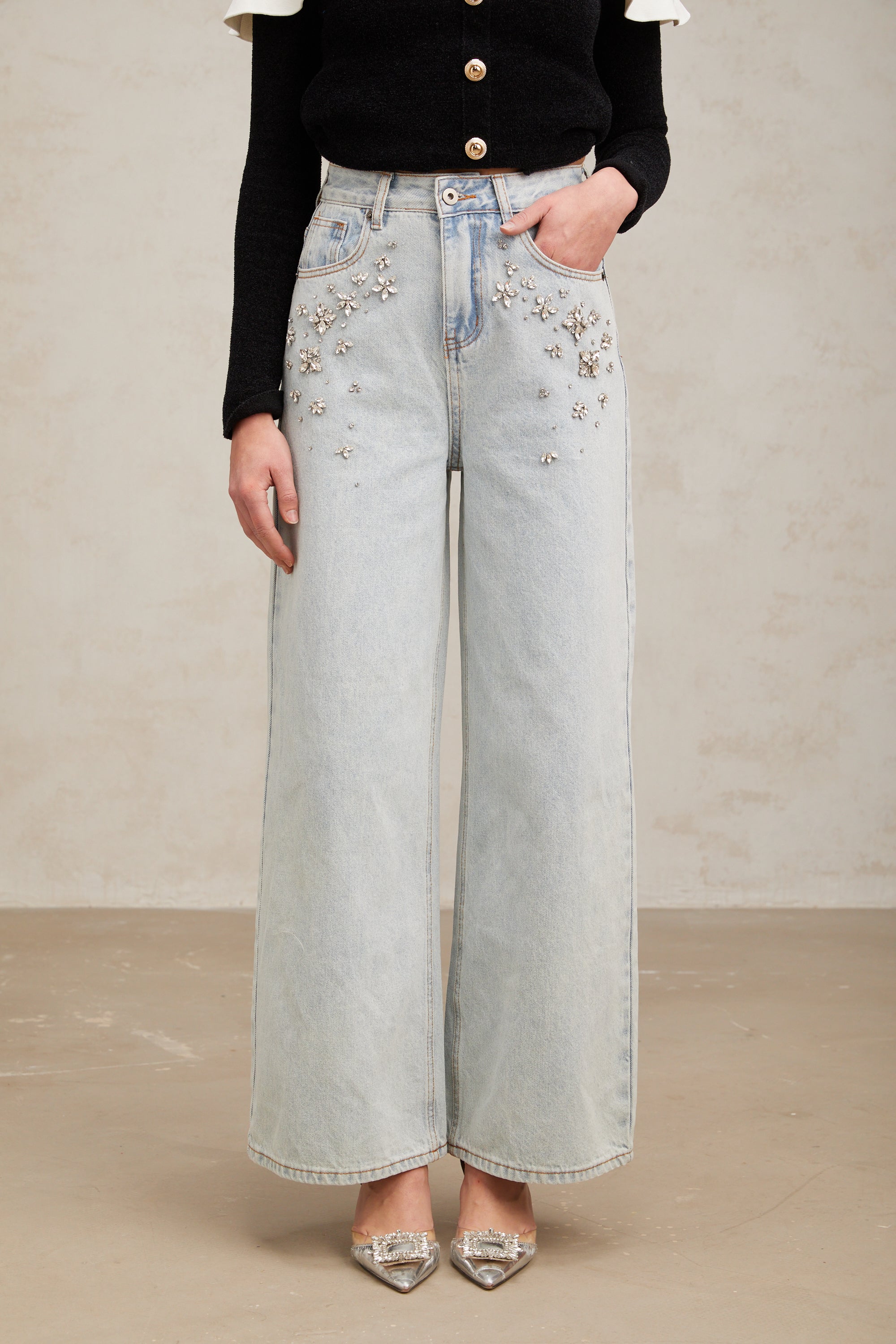Women's light blue wide-leg denim jeans with crystal embellishment on hip pockets