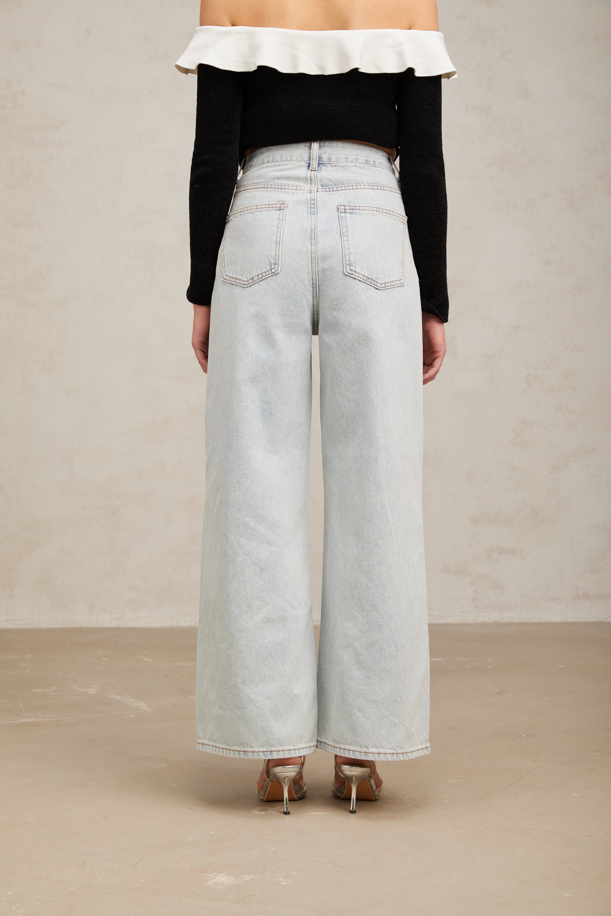 Women's light blue wide-leg denim jeans with crystal embellishment on hip pockets