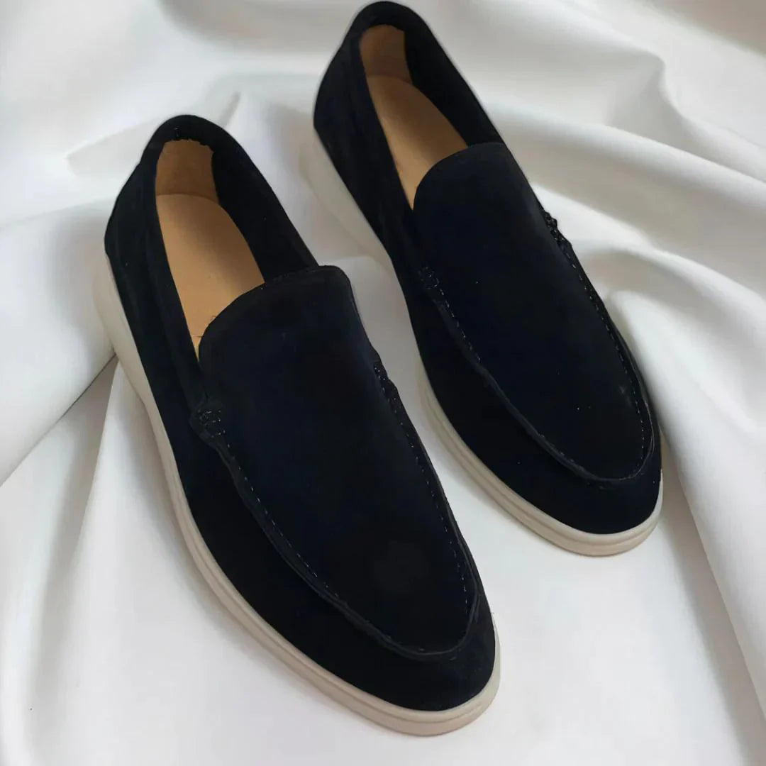 Black and navy suede loafers with cream sole and moc-toe stitching