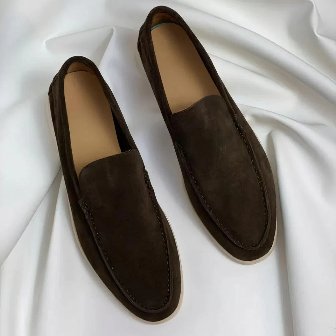 Black and navy suede loafers with cream sole and moc-toe stitching