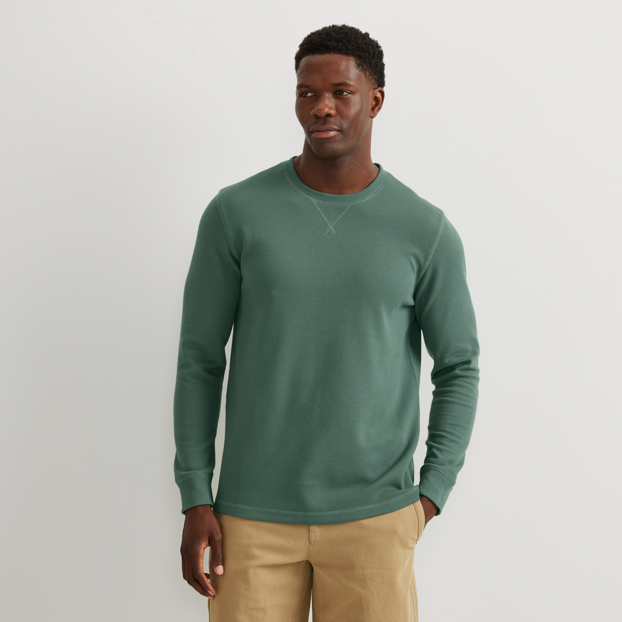 Men's crew neck long sleeve top with fine ribbed texture and ribbed cuffs
