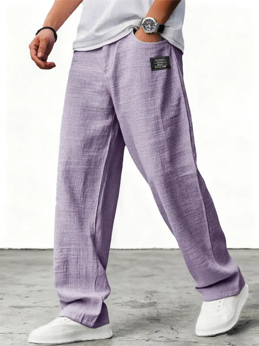 Man wearing blue wide leg relaxed fit trousers with white sneakers