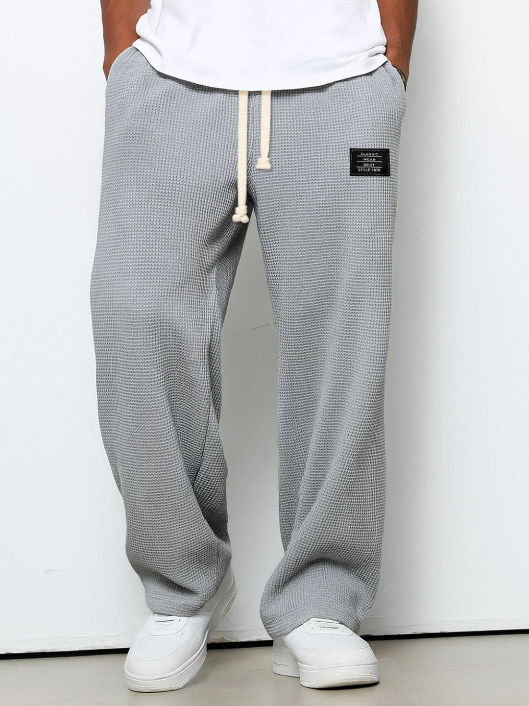 Men's wide leg textured trousers with drawstring waist, shown in blue and cream variants