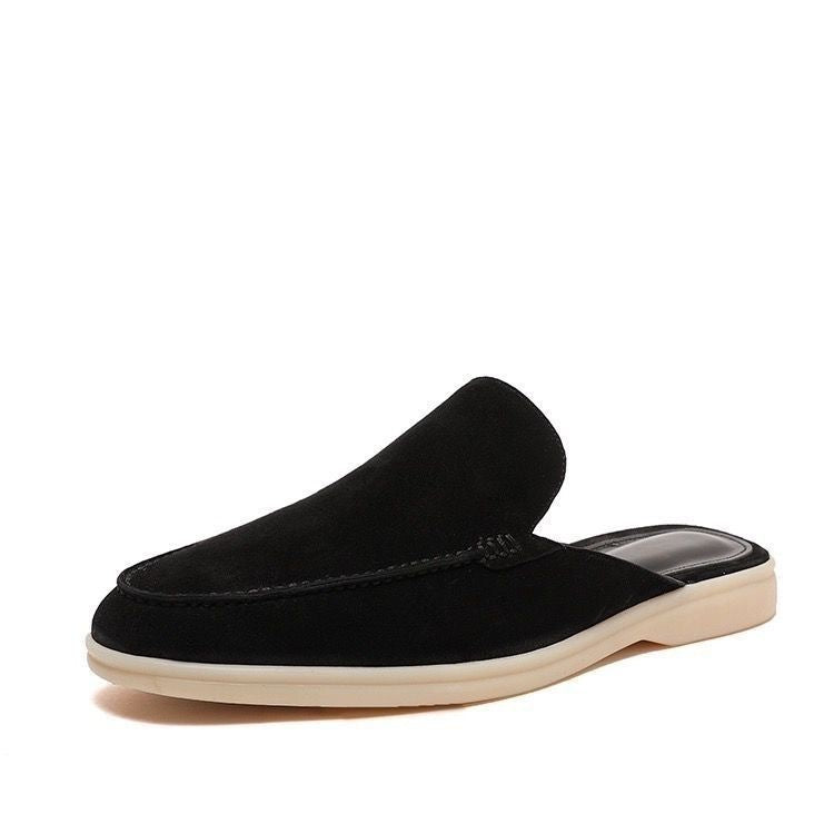 Black loafer mule with cream-coloured sole, shown from the side profile