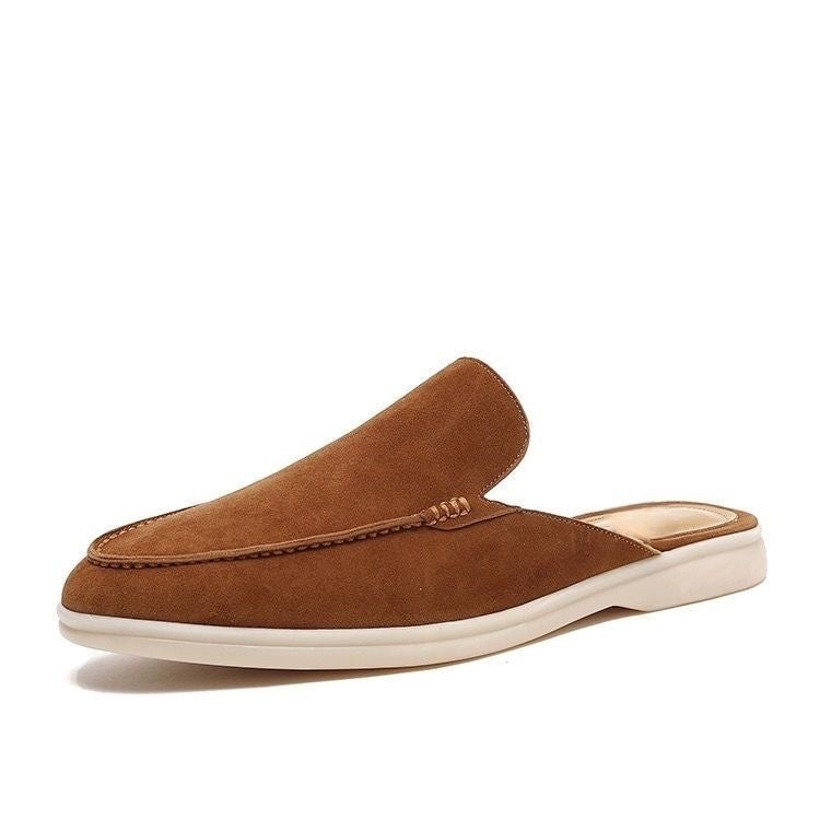 Black loafer mule with cream-coloured sole, shown from the side profile