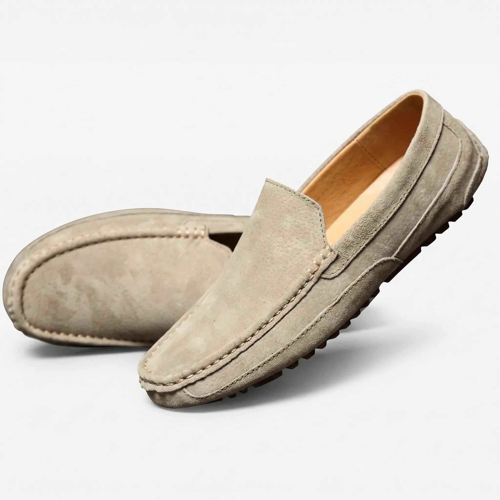 Men's slip-on moccasin loafers with stitched trim and ridged soles