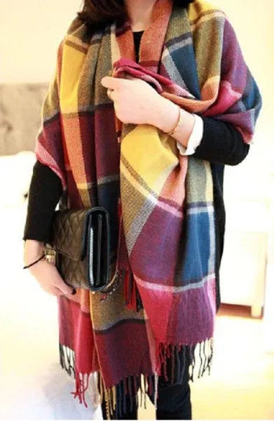 Oversized fringed wrap scarf shown draped around the shoulders and neck