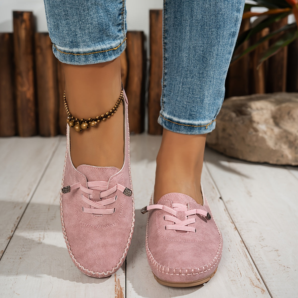Women's grey and beige lace-up moccasin loafers with cushioned sole, worn with jeans