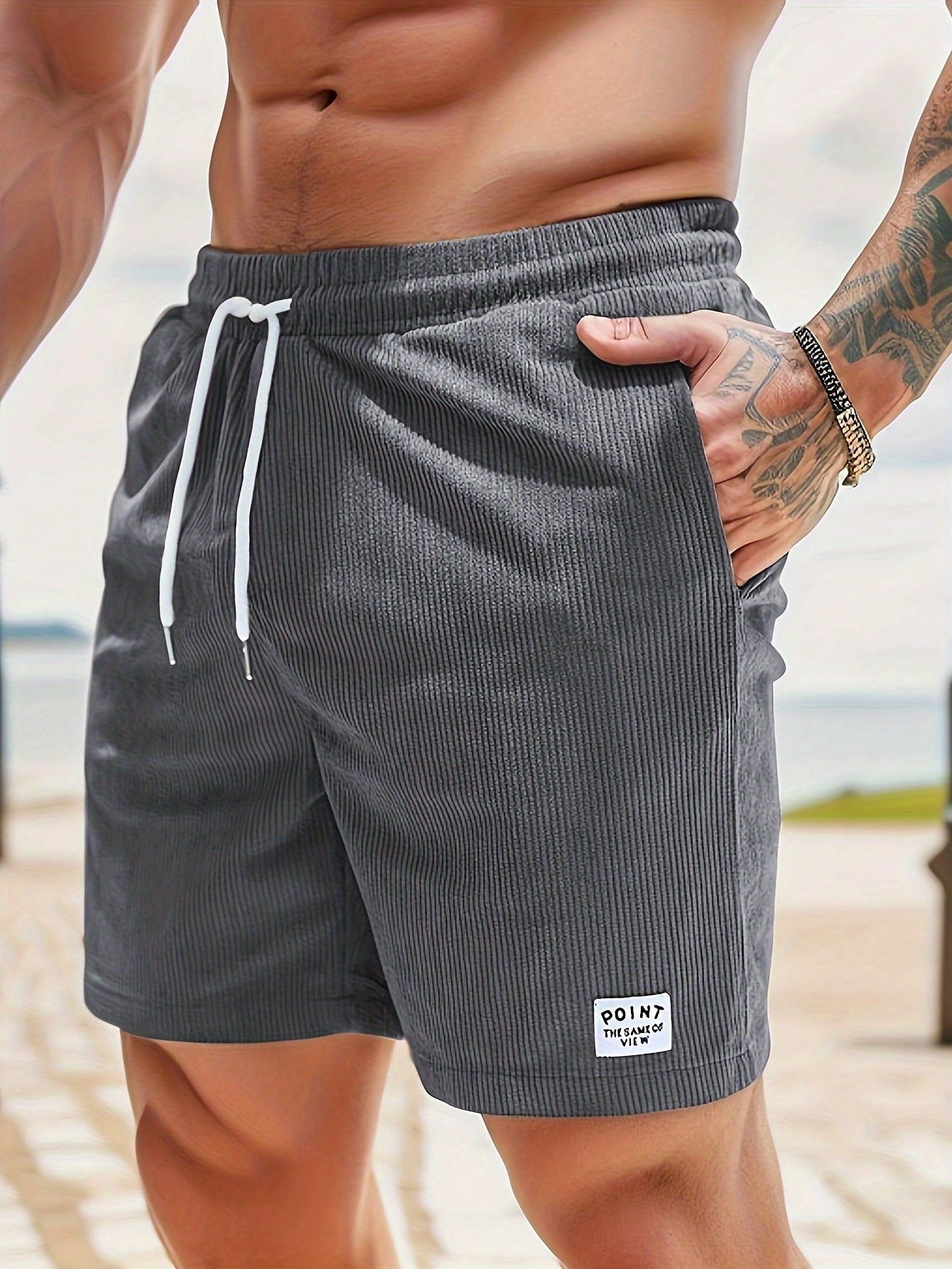 Men's relaxed fit shorts with elastic waist and drawstring, shown in green and beige