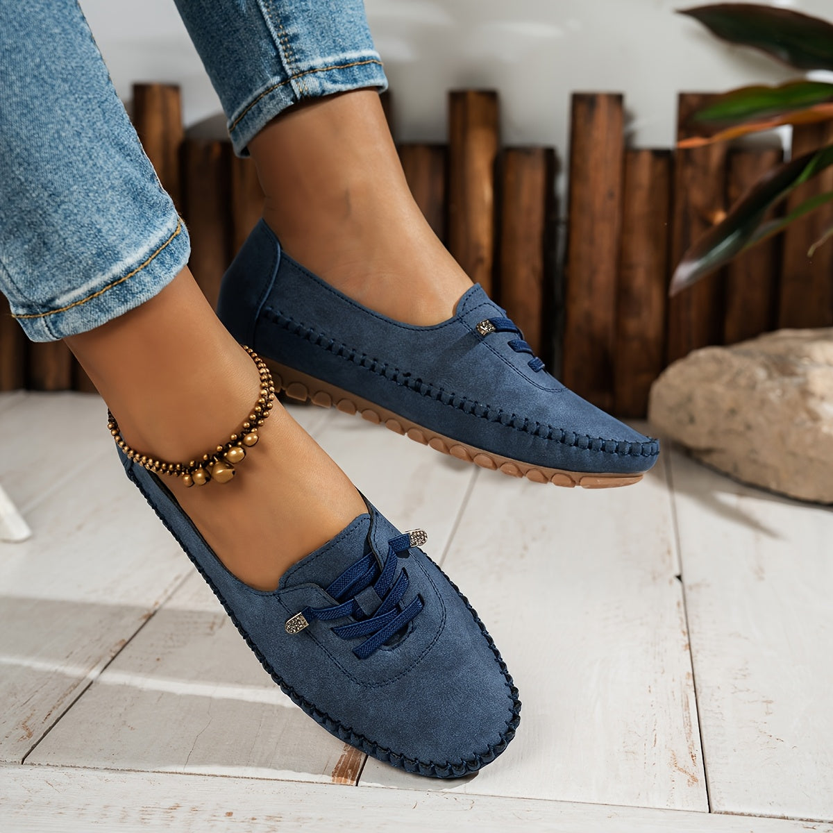 Women's grey and beige lace-up moccasin loafers with cushioned sole, worn with jeans