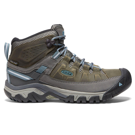 Green high-top hiking boot with blue-grey laces and lugged sole