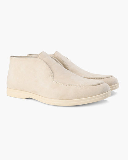 Unisex ankle-height slip-on loafers with rounded moc toes and stitched apron details
