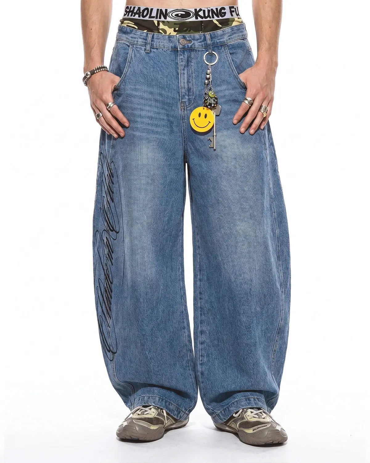 Light blue barrel-leg jeans with black script graphic and five-pocket design