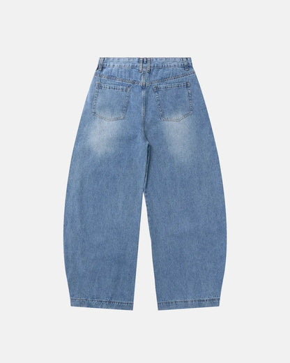 Light blue barrel-leg jeans with black script graphic and five-pocket design