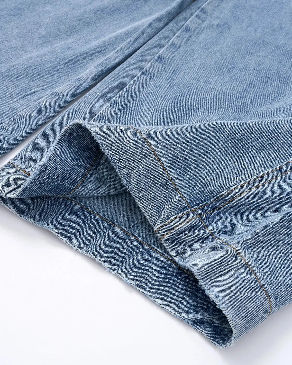 Light blue barrel-leg jeans with black script graphic and five-pocket design