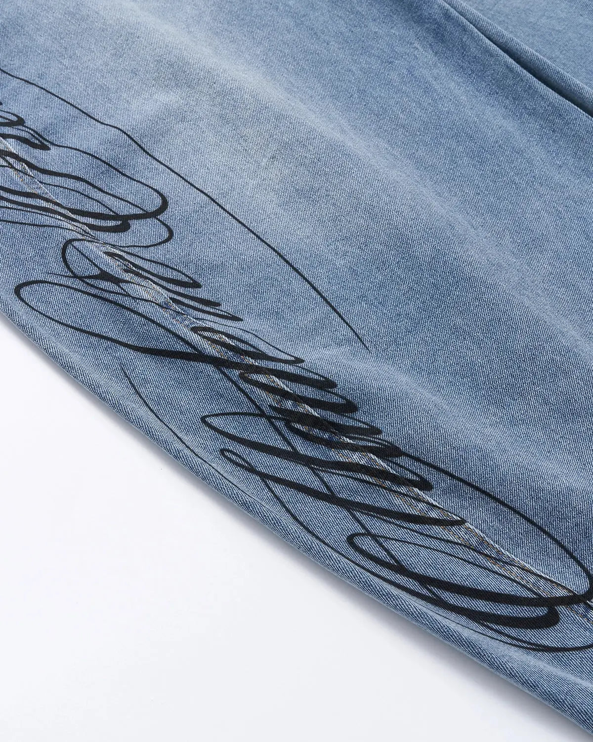 Light blue barrel-leg jeans with black script graphic and five-pocket design