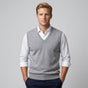 Men's sleeveless V-neck knitted sweater vest layered over a collared shirt