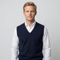 Men's sleeveless V-neck knitted sweater vest layered over a collared shirt