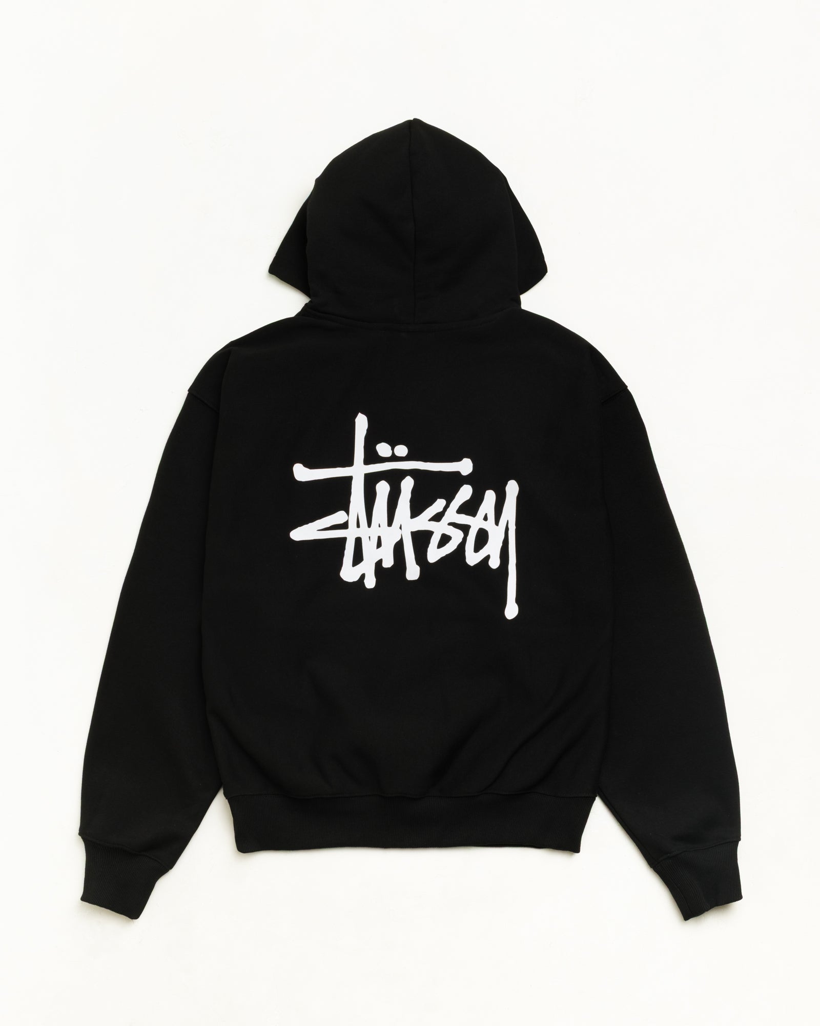 Men's black Stüssy hoodie with large white logo graphic on back and small chest logo, drawstring hood