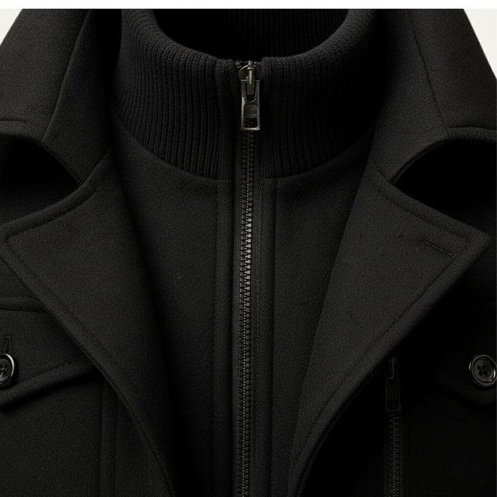 Men's long structured button coat with raised collar, chest pockets and cuff tabs