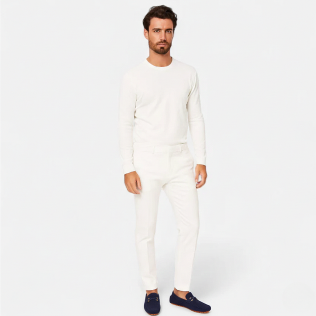 Men's perforated slip-on loafers with decorative vamp detail and flat ridged soles