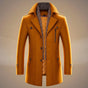 Men's long structured coat with notched lapels, patterned trim, buttons and multiple pockets