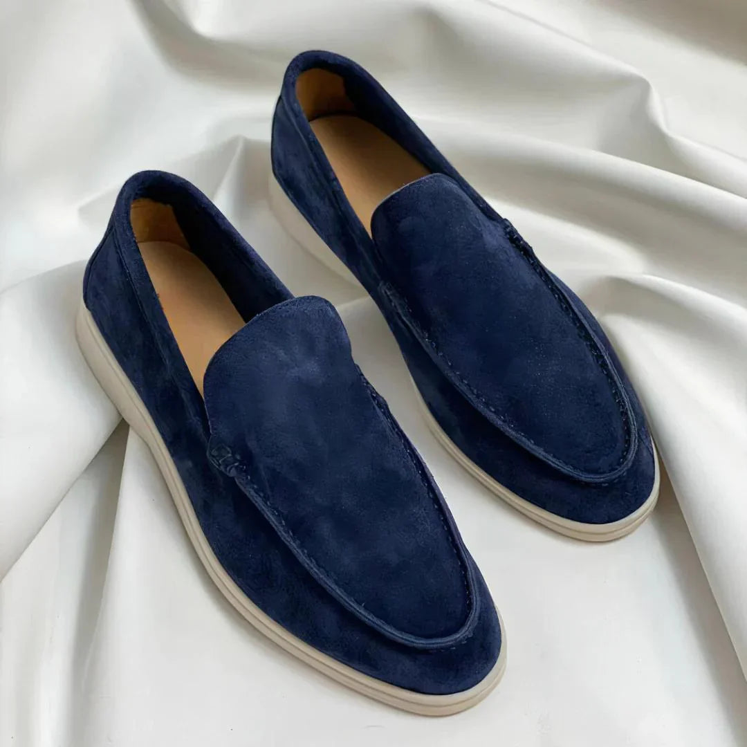 Black and navy suede loafers with cream sole and moc-toe stitching