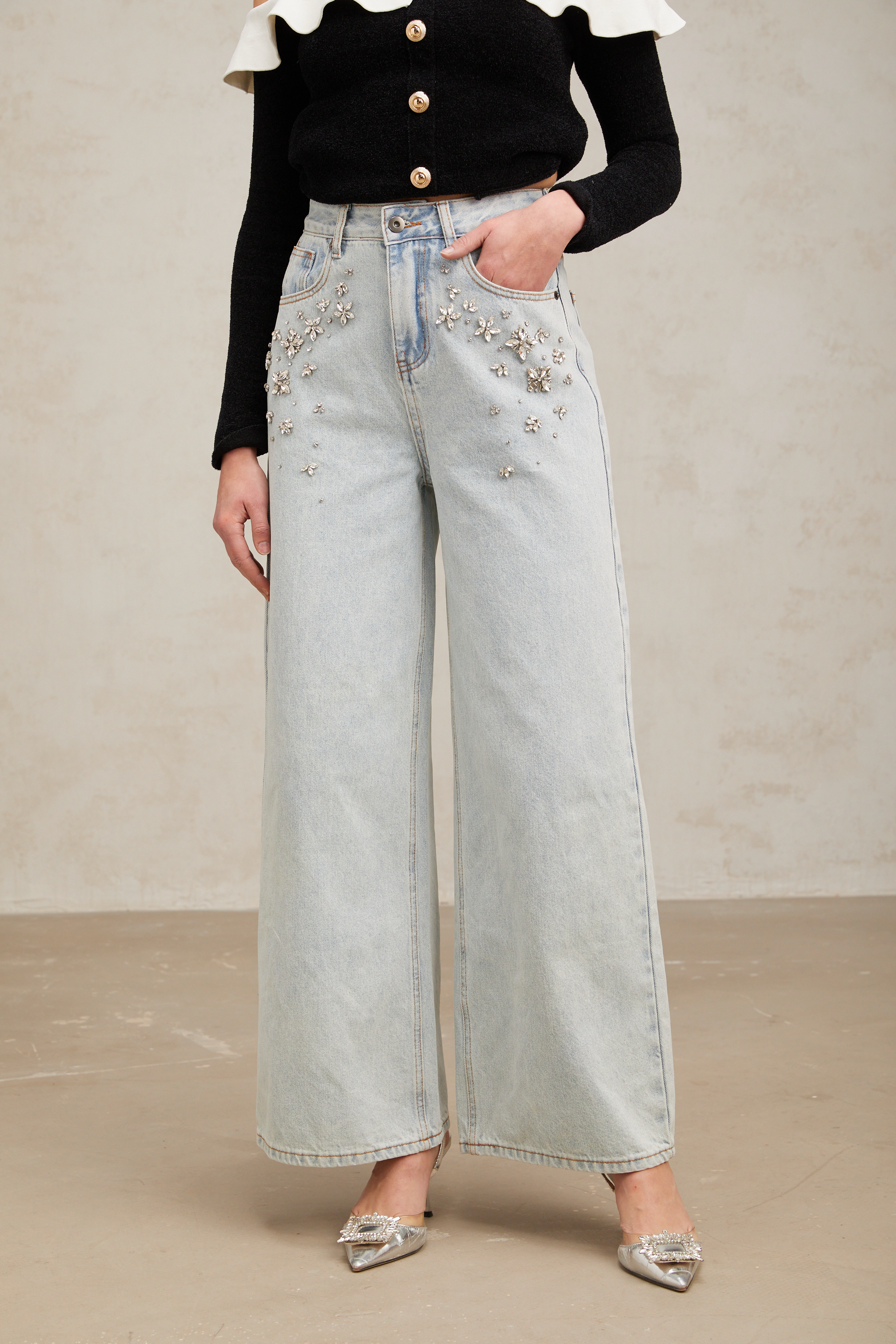 Women's light blue wide-leg denim jeans with crystal embellishment on hip pockets