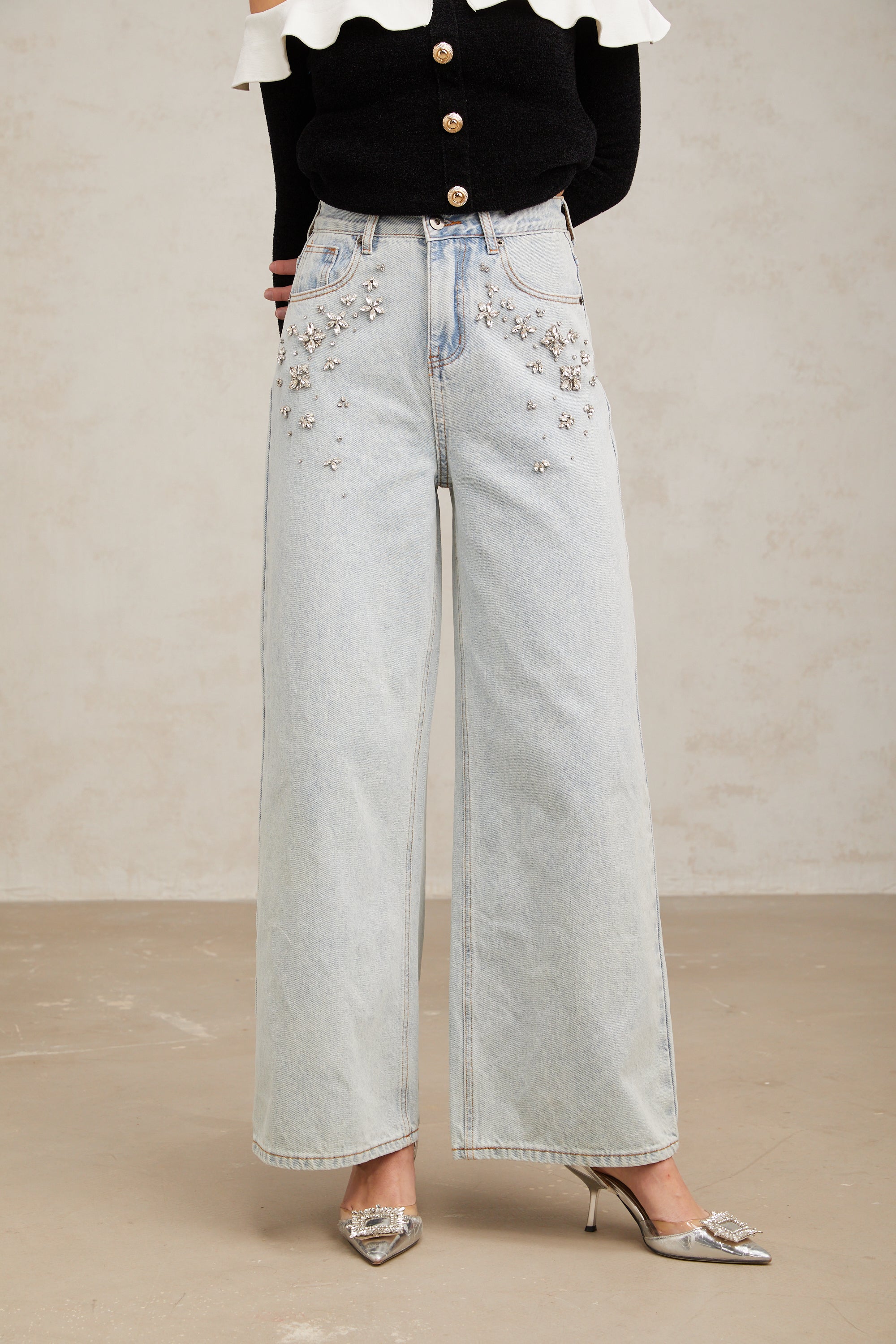 Women's light blue wide-leg denim jeans with crystal embellishment on hip pockets