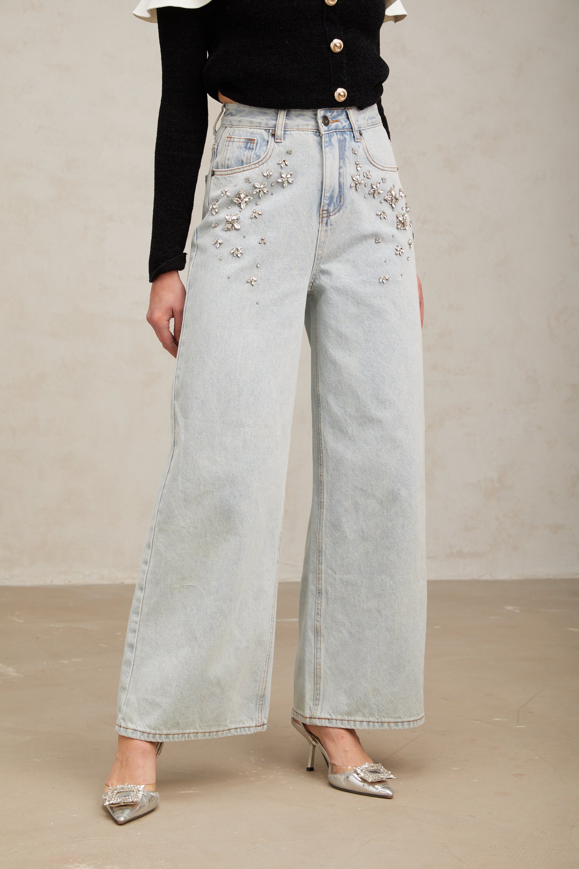 Women's light blue wide-leg denim jeans with crystal embellishment on hip pockets