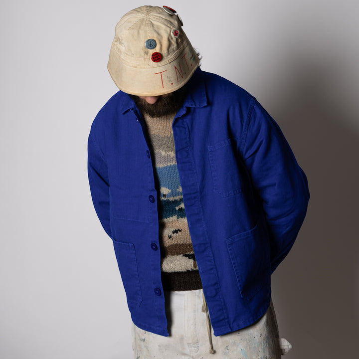 Men's blue collared work jacket with button front and patch pockets
