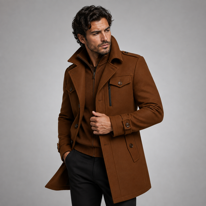 Men's long structured button coat with raised collar, chest pockets and cuff tabs