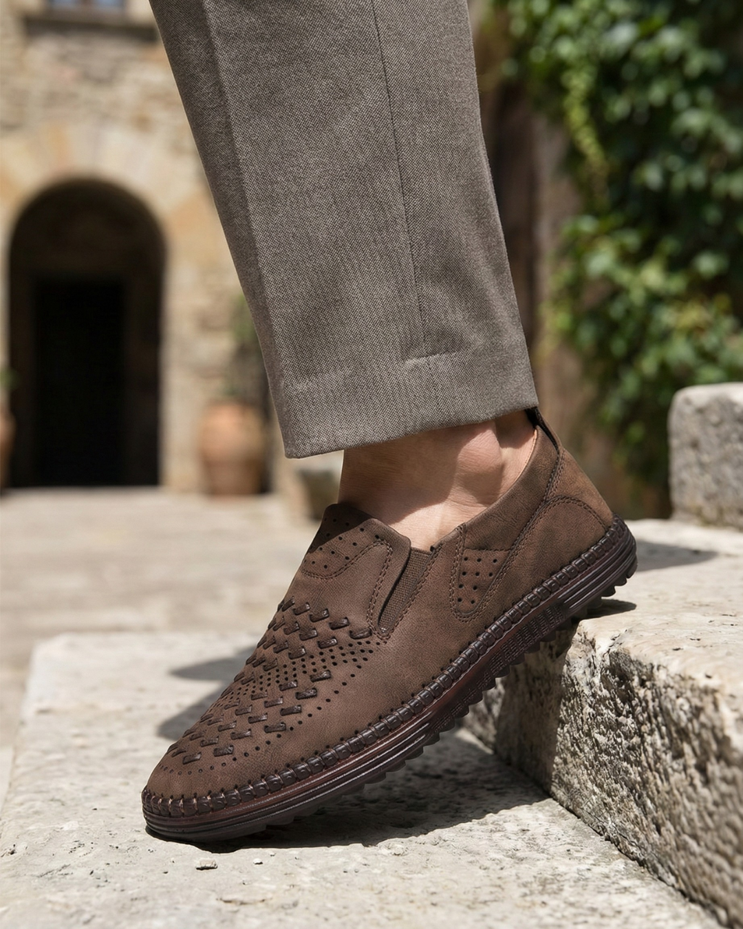 Perforated slip-on loafers with stitched sole trim and ridged tread