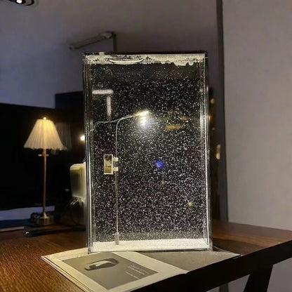 Clear rectangular bubble display lamp standing on a wooden table