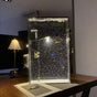 Clear rectangular bubble display lamp standing on a wooden table