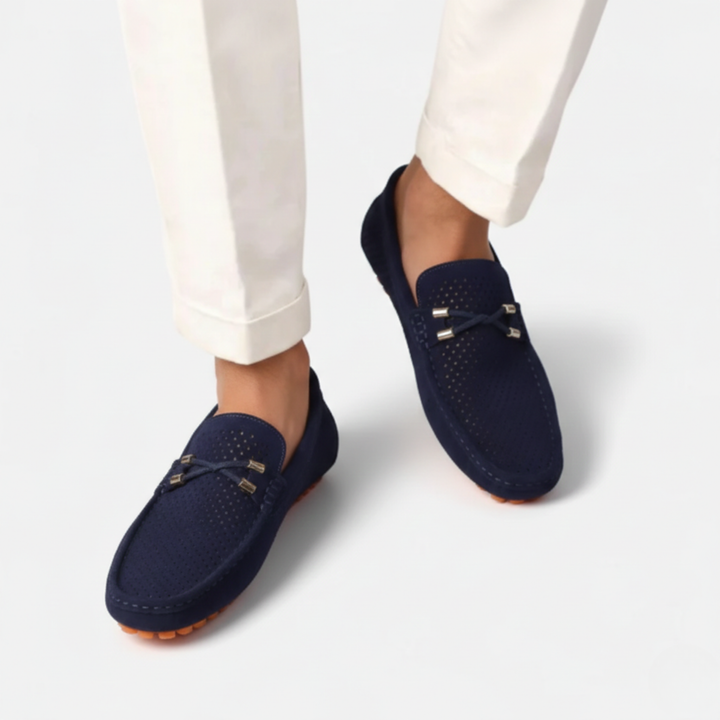 Men's perforated slip-on loafers with decorative vamp detail and flat ridged soles