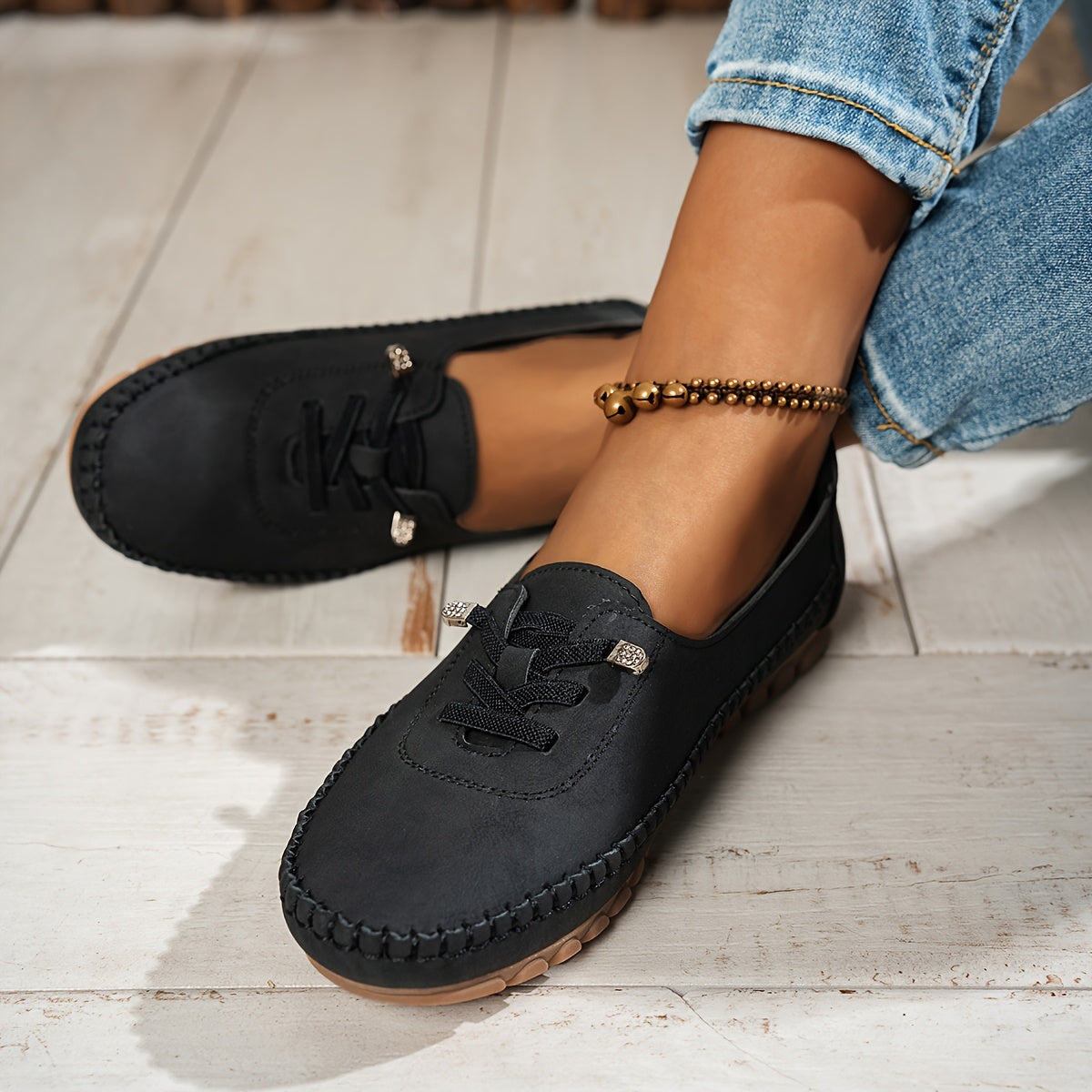 Women's grey and beige lace-up moccasin loafers with cushioned sole, worn with jeans