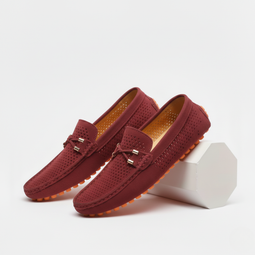Men's perforated slip-on loafers with decorative vamp detail and flat ridged soles