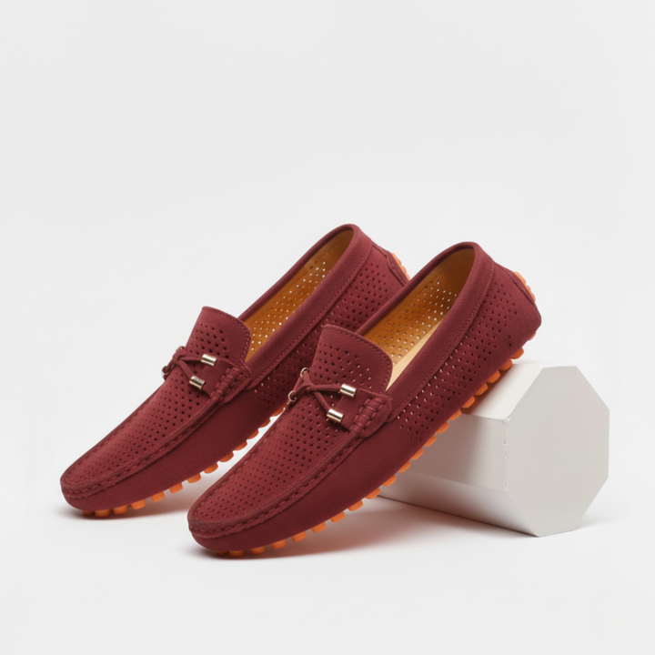 Men's perforated slip-on loafers with decorative vamp detail and flat ridged soles