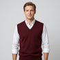 Men's sleeveless V-neck knitted sweater vest layered over a collared shirt