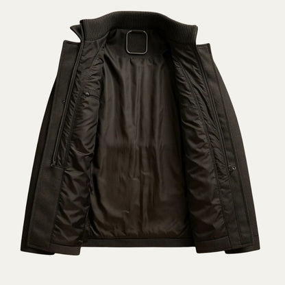 Men's long structured button coat with raised collar, chest pockets and cuff tabs