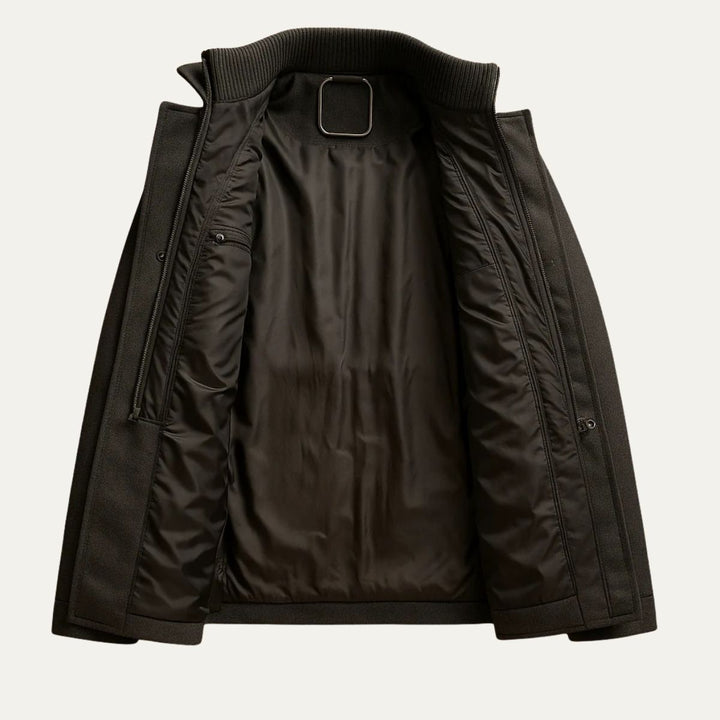 Men's long structured button coat with raised collar, chest pockets and cuff tabs