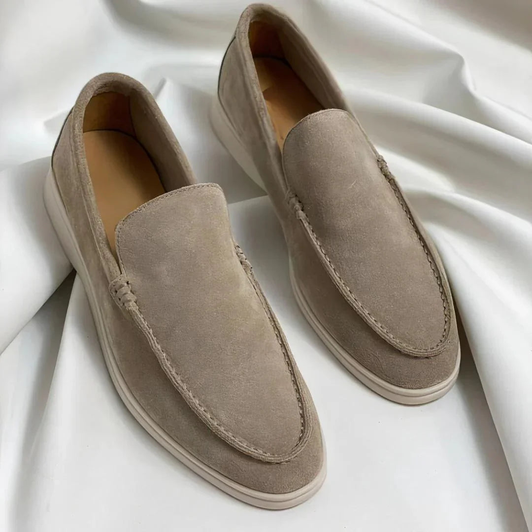 Black and navy suede loafers with cream sole and moc-toe stitching