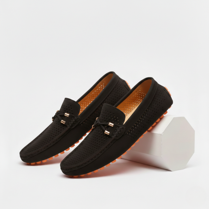 Men's perforated slip-on loafers with decorative vamp detail and flat ridged soles