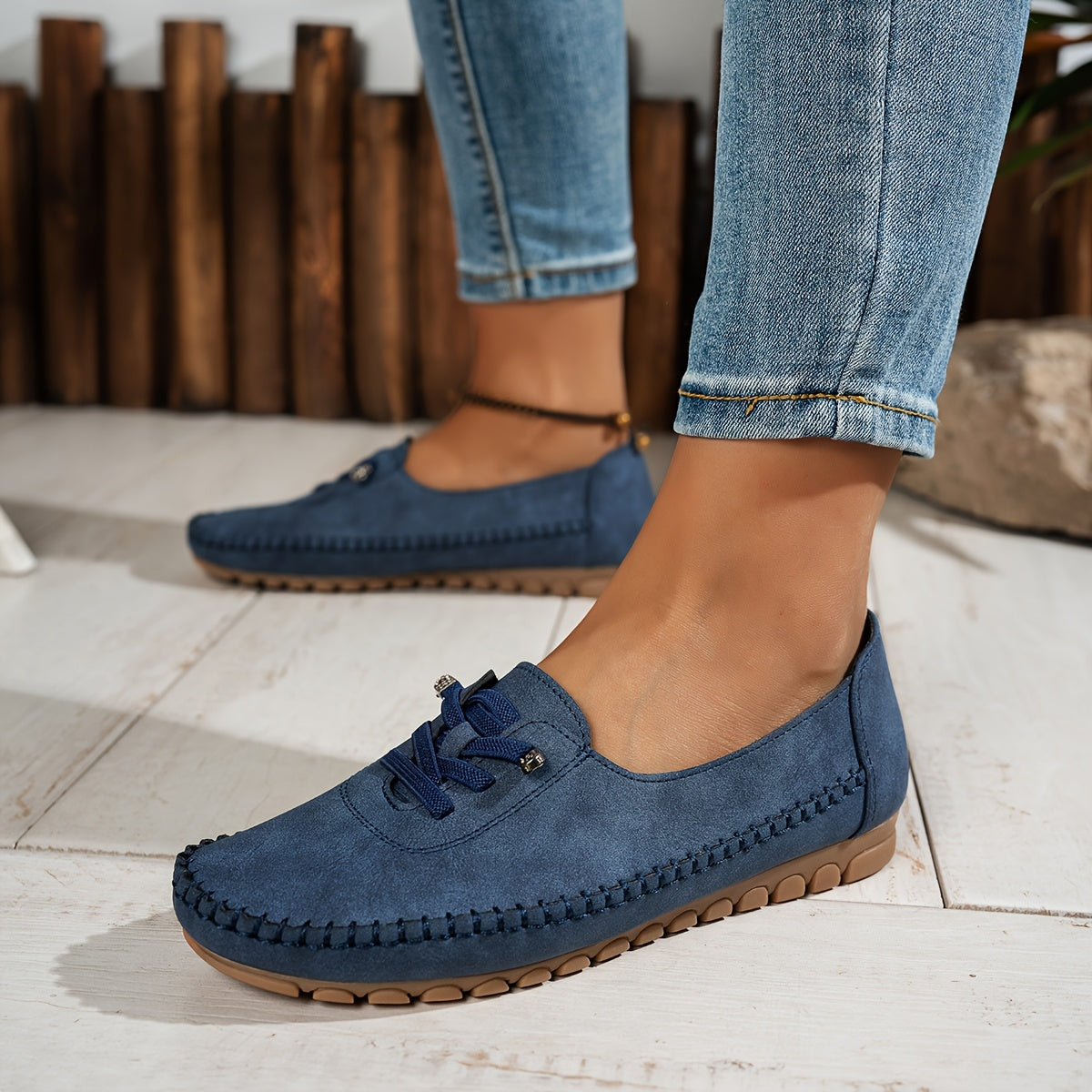 Women's grey and beige lace-up moccasin loafers with cushioned sole, worn with jeans