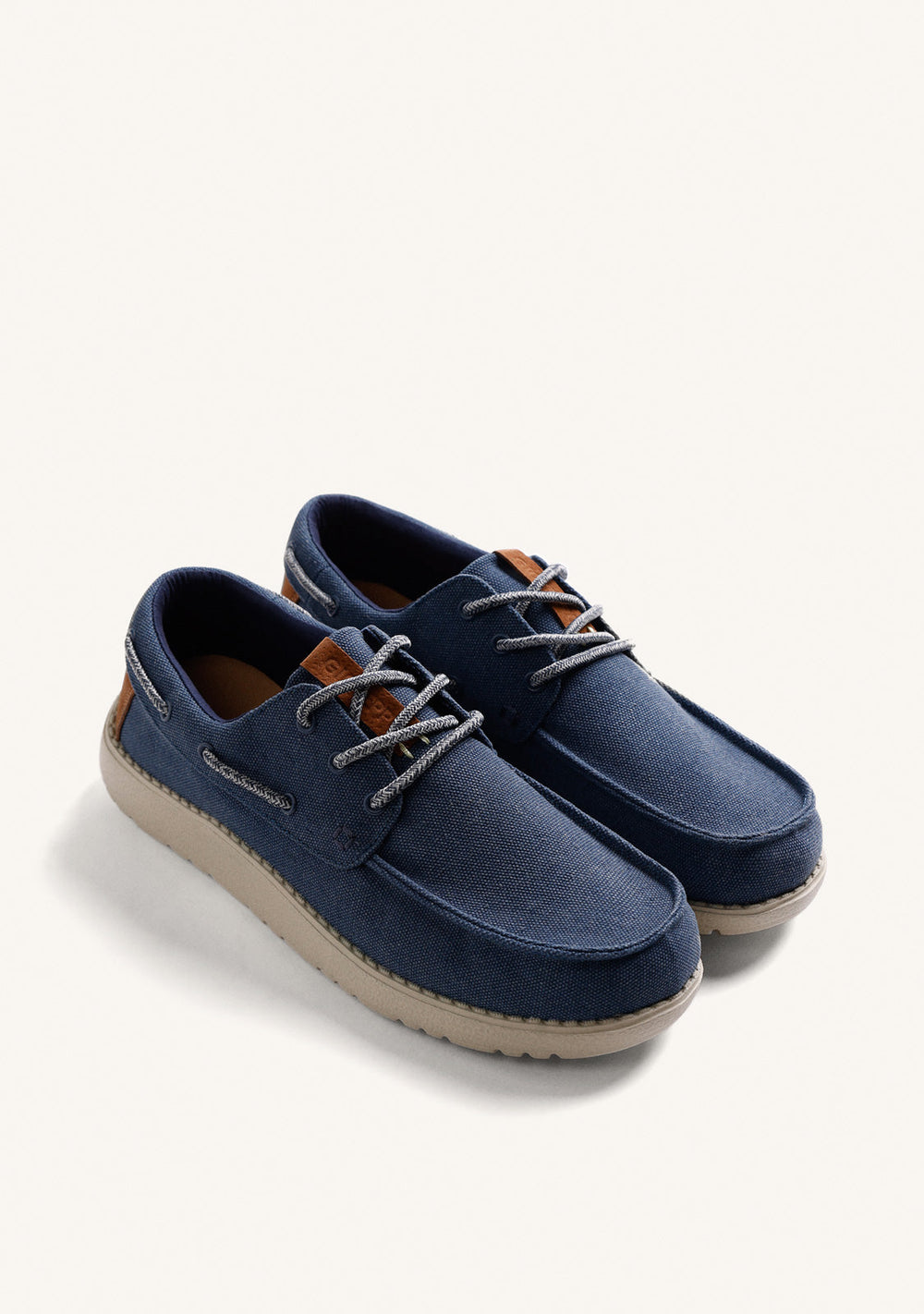 Navy Wallabee loafers with grey laces, brown heel detail and flat textured soles