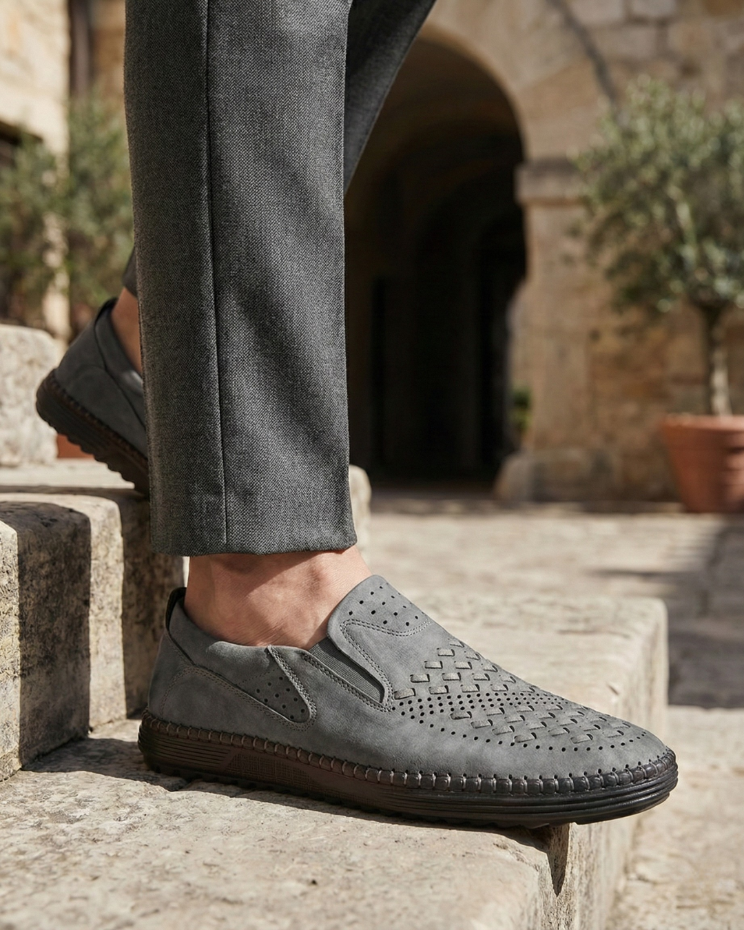 Perforated slip-on loafers with stitched sole trim and ridged tread