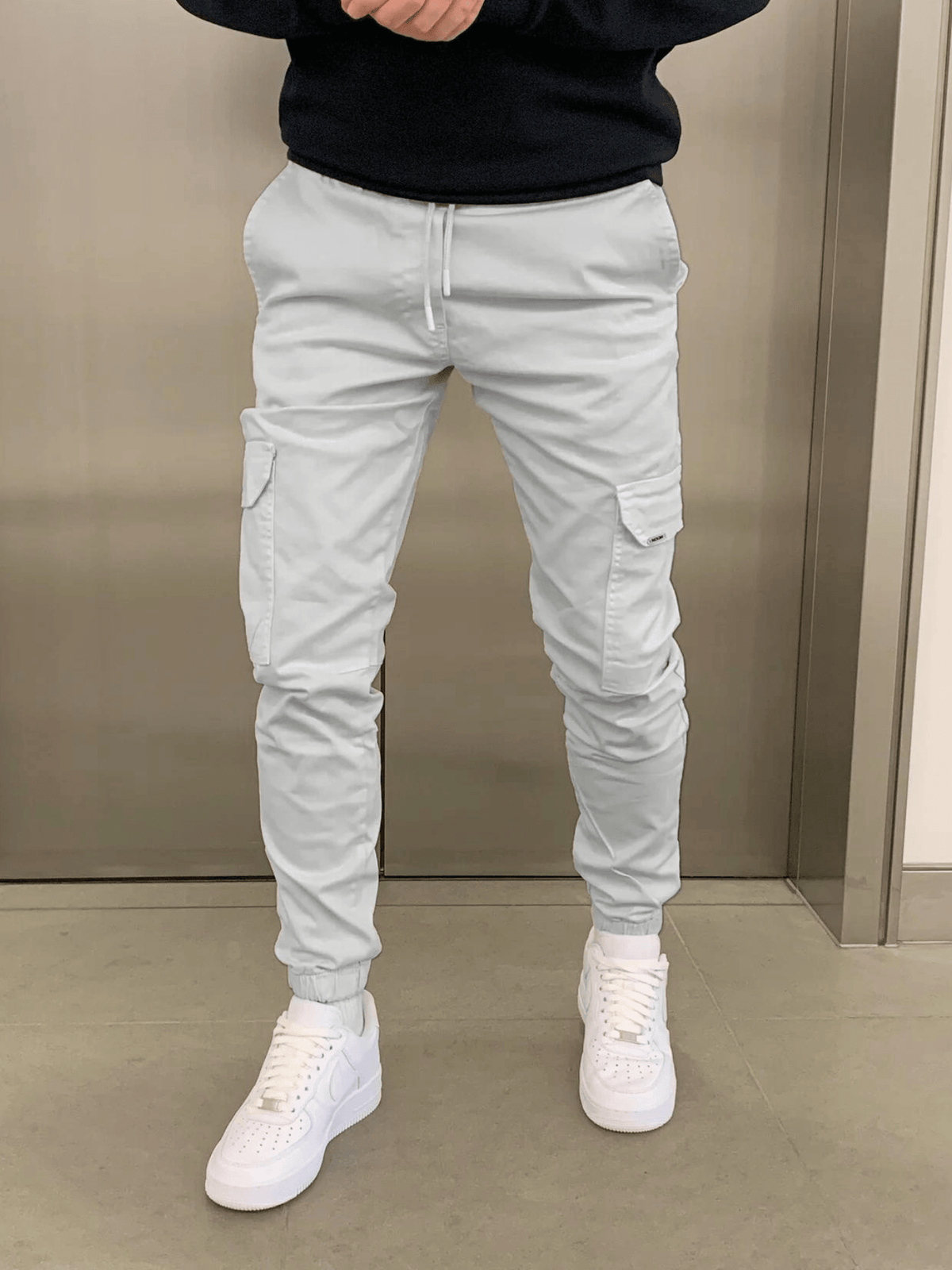 Men's tapered cargo trousers with drawstring waist, thigh pockets and elasticated cuffs
