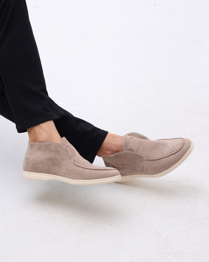 Unisex ankle-height slip-on loafers with rounded moc toes and stitched apron details