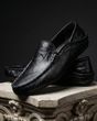 Unisex moc toe loafers with braided side trim and flat dark soles